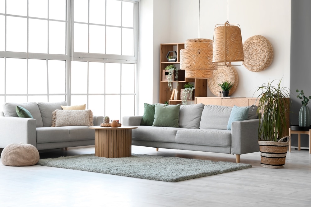 Flooring Trends. Interior of bright living room with cozy grey sofas and coffee table on soft carpet.