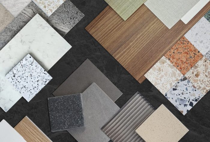 Flooring Options. set of interior material sample in top view contains terrazzo stones, tiles, wooden laminated, glass, marbles placed on black marble table. interior mood and tone samples board.