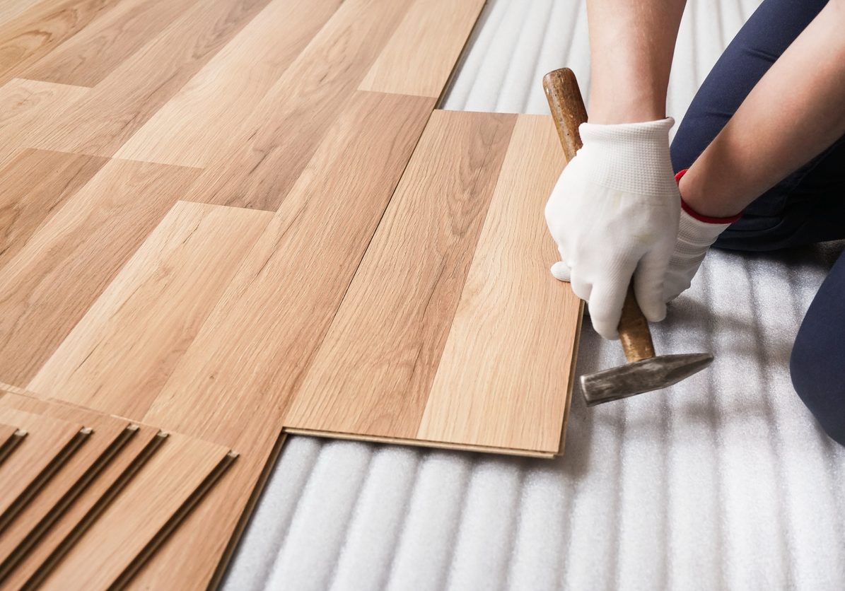 man installing laminate flooring