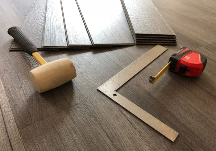 What Is the Difference Between Solid & Engineered Hardwood? interior installation Engineered Hardwood floor and flooring tool.