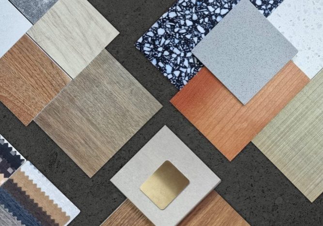 Flooring Solutions for Every Home. palette of interior material samples in top view contains wooden tiles, artificial stone, terrazzo, gold stainless, drapery, laminated placed on black marble stone table.